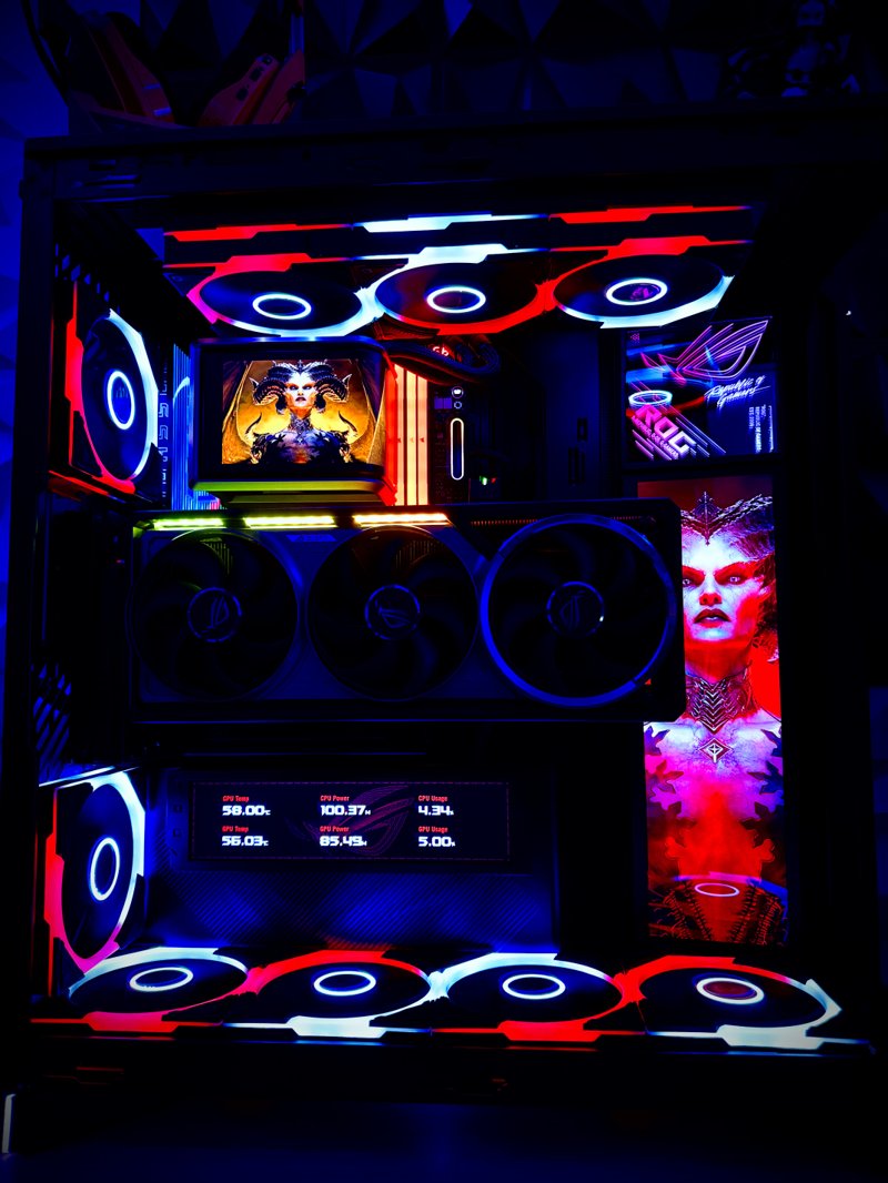 Black gaming PC with red and blue RGB fans and multiple internal displays