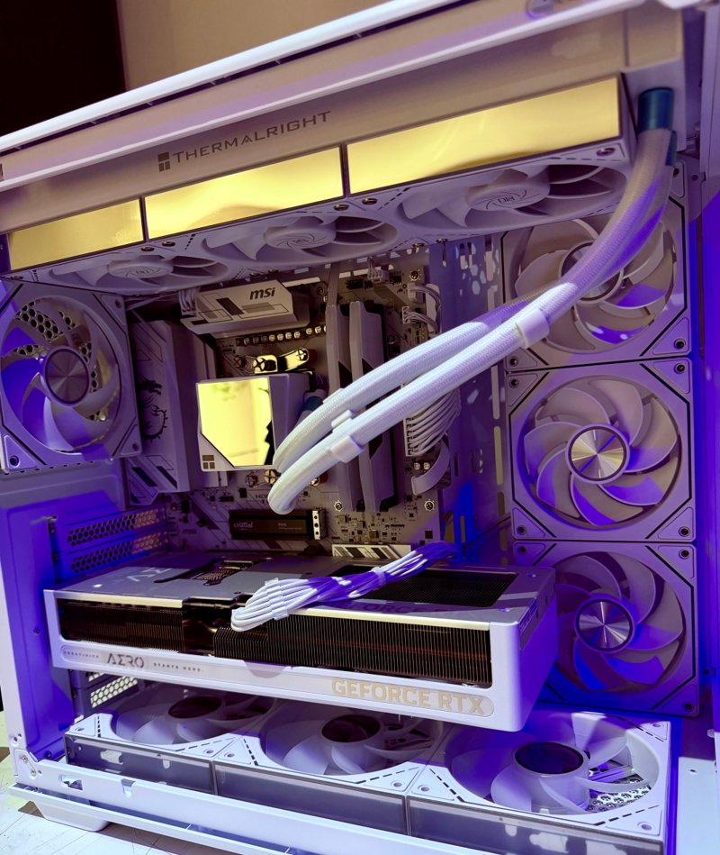 White gaming PC with white liquid-cooling tubes, RGB fans and a triple-fan graphics card
