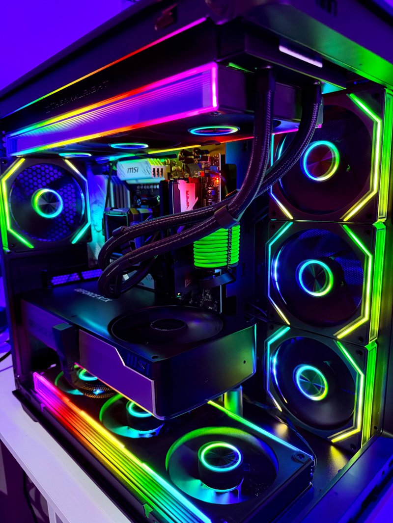 Black gaming PC with multicolour RGB fans and illuminated cables