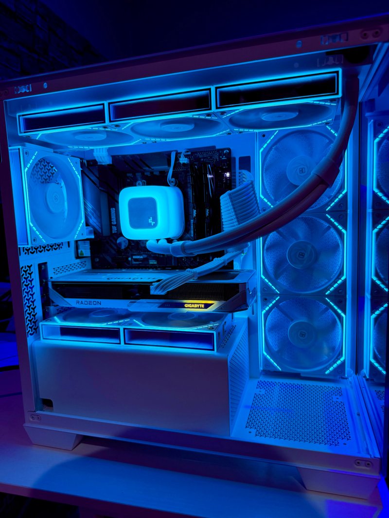 White gaming PC with blue lighting and a liquid cooler