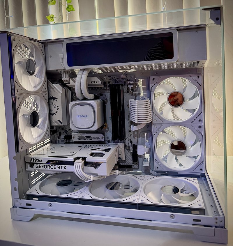 White gaming PC showing its liquid cooler, graphics card and case fans