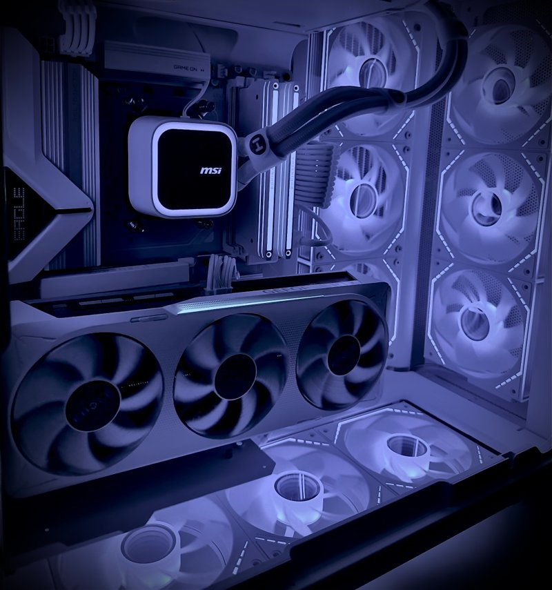 Close-up of a white gaming PC with a triple-fan graphics card