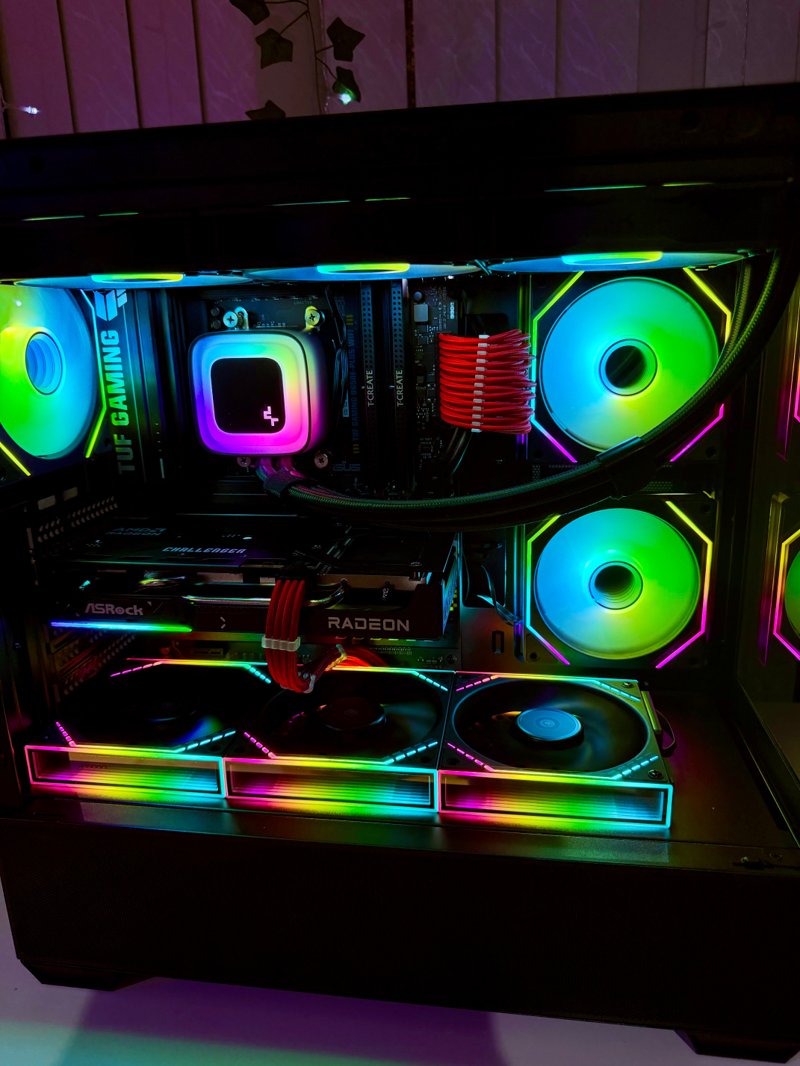 Black gaming PC with multicolour RGB cooling fans and a liquid cooler