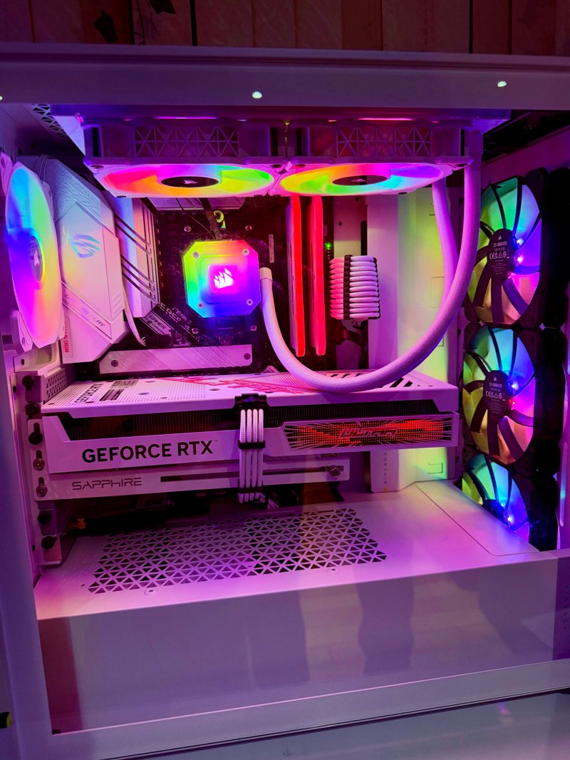 White gaming PC with pink and rainbow lighting and a GeForce RTX graphics card