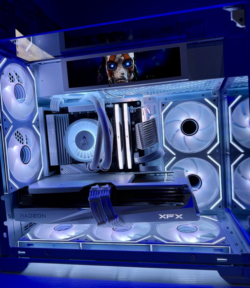White gaming PC with blue and white RGB lighting, a Radeon graphics card and an internal display